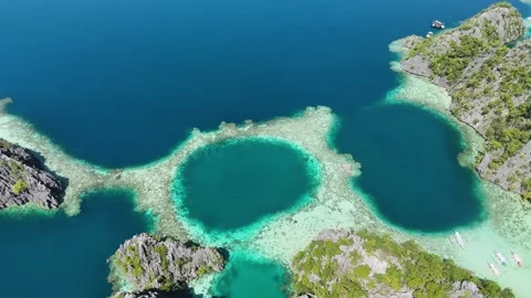Aerial drone shot capturing the serene twin lagoon in Coron, Palawan. Video stock 295909573