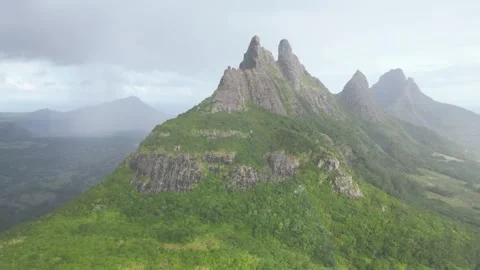 Aerial drone shot capturing the steep volcanic peaks and green slopes of Stock Footage 341032383