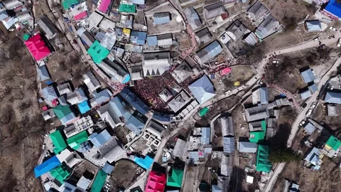 Aerial drone shot capturing the unity and joy of the Sangla Holi festival, where Stock Footage 304948016