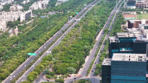 Aerial drone shot capturing a wide road in Noida with fast-moving traffic. Stock Footage 312487730