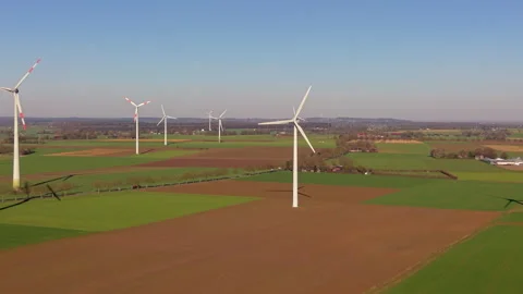 An aerial drone shot capturing a wind farm with massive wind turbines standing Vídeos de archivo 336407211