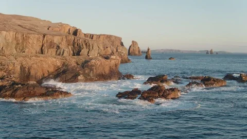 Aerial drone shot of cliffs in Braewick, Shetland during a sunset Stock Footage 88824020