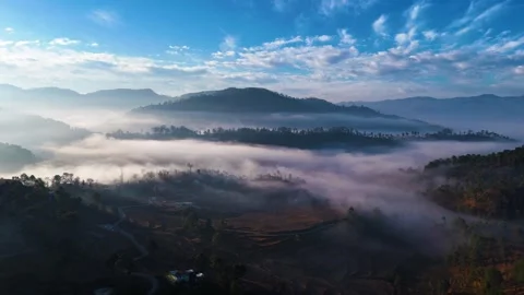 Aerial drone shot of cloud river forming in the mountains in the morning Video stock 296673840