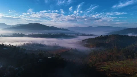 Aerial drone shot of cloud river forming in the mountains in the morning Video stock 296673871