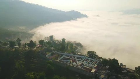 Aerial drone shot of cloud river forming in the mountains in the morning crowded Stock Footage 296674227