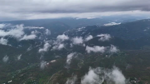 Aerial drone shot of clouds drifting between high-altitude mountain valleys Stock Footage 310748118