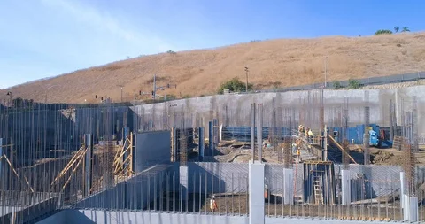 Aerial drone shot of construction site in progress with workers in 4K Stock Footage 85651542