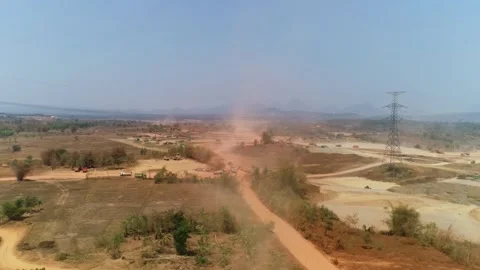 Aerial drone shot of construction site road with dust and trucks Stock Footage 346190533