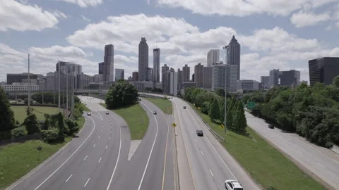 Aerial Drone Shot Day Push In from Highway through City Skyline Stock Footage