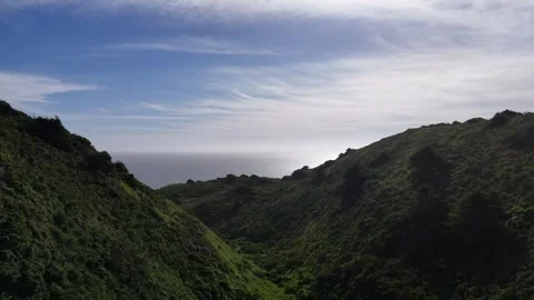 Aerial Drone Shot of a Deep Valley Opening to the Pacific Ocean Coast Video stock 331976745