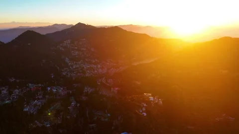Aerial drone shot displaying sunrays breaking through the clouds, illuminating Stock Footage 310747969