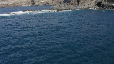Aerial drone shot of dramatic cliffs with waves crashing in Tenerife Stock Footage 143387604