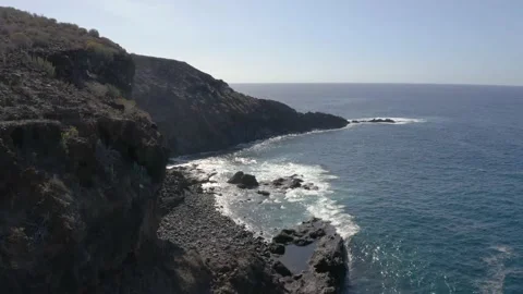 Aerial drone shot of dramatic cliffs with waves crashing in Tenerife Stock Footage 143387739