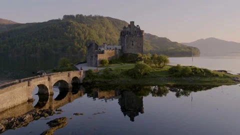 Aerial drone shot of Eilean Donan Castle in Scotland at sunset Stock Footage 132877447