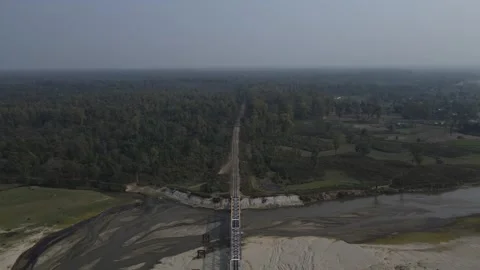 Aerial Drone shot of an empty railway track Bridge crossing river in India Stock Footage 261035944