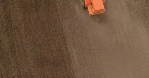 Aerial drone shot of a farmer cultivating fields Stock Footage