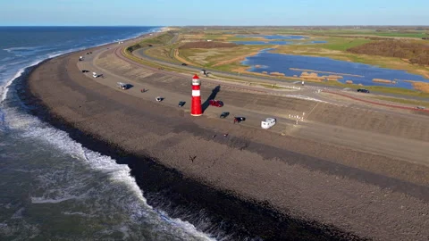 An aerial drone shot features the iconic red and white cast-iron Noorderhoofd Video stock 335317354