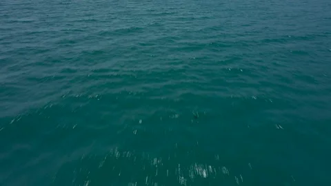 Aerial drone shot flying above blue ocean water towards big island in Nha Trang Stock Footage 166554053