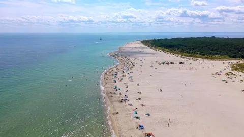 Aerial drone shot flying backward over a wide sandy beach in Hel on the Hel Stock Footage 342236487