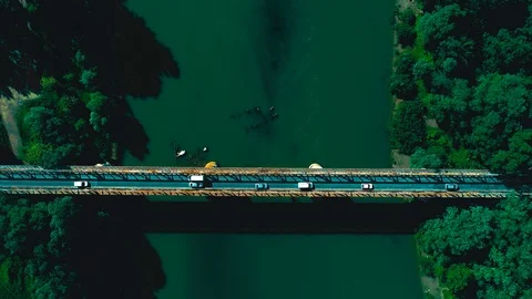 Aerial drone shot : flying forward along vehicles crossing road bridge over a Stock Footage 94974009