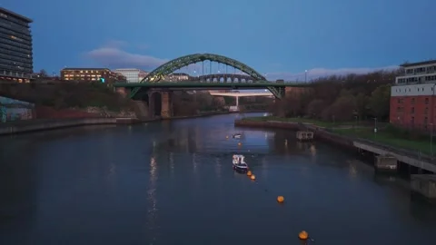 Aerial drone shot flying forward and climbing over the River Wear in Sunderland Stock Footage 332708657