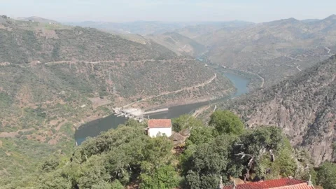 Aerial, drone shot flying forward over the Douro River, revealing Valeira Dam 動画素材 345108690