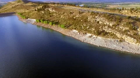 Aerial Drone Shot Flying Over Water Approaching Shore Stock Footage