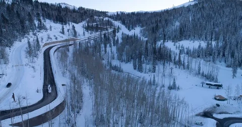 Aerial drone shot flying slowly over the snow high hills around Park City as a Stock Footage 92772053