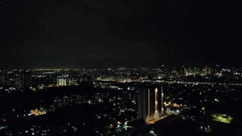 Aerial drone shot flying towards skyscraper at night over gurgaon showing Stock Footage 243473167