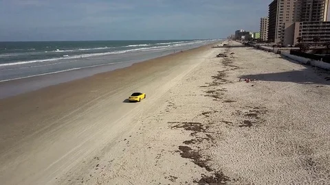 Aerial drone shot of ford mustang on the beach Stock Footage
