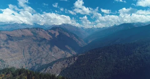 Aerial drone shot of forest and high altitude mountains. blue sky Stock Footage 159042353