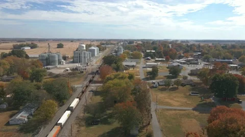 Aerial drone shot of a freight train in the evening departing from the Stock Footage 220261366