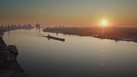 Aerial drone shot of a freighter passing through the Detroit River at daybreak. Stock Footage 317535846