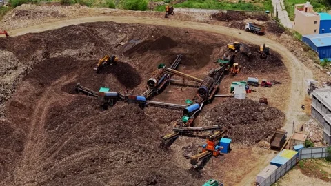 Aerial drone shot of garbage dump yard with waste processing machinery in 스톡 동영상 343829619
