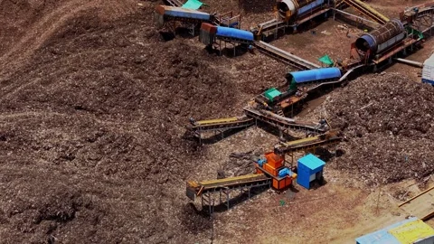 Aerial drone shot of garbage dump yard with waste processing machinery in 스톡 동영상 343830753