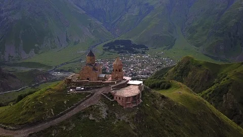 Aerial Drone Shot of Gergeti Trinity Monastery Kazbegi Georgia with Beautiful Mo Stock Footage 123340695