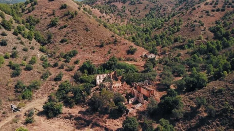 Aerial drone shot gliding over abandoned, crumbling stone ruins Stock Footage 345669432
