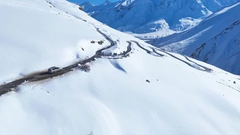 Aerial drone shot highlighting a dramatic mountain pass in Spiti, where a Stock Footage 304952440