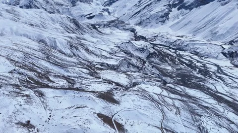 Aerial drone shot highlighting the dramatic contrast between the deep valleys Stock Footage 304957193