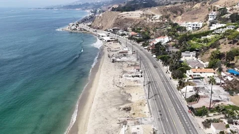 Aerial drone shot of L.A. fires that burnt homes along PCH in Malibu California Stock Footage 317719201