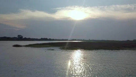 Aerial drone shot of lagoon with backlight and flare during sunset Video stock 233648617