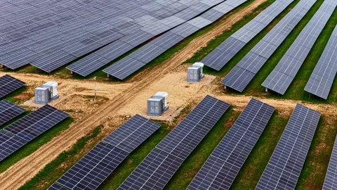 Aerial Drone Shot of Large Solar Panel Array and Inverters in Rural Green Fields Stock-Footage 334692838