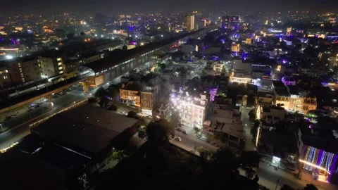 Aerial drone shot locked over small houses and busy road with fireworks on the Stock Footage 319910342