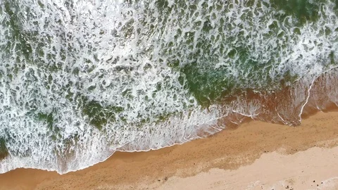 Aerial Drone Shot Looking Down At Beach And Waves Coming Onto Sand 4K 動画素材 107286947