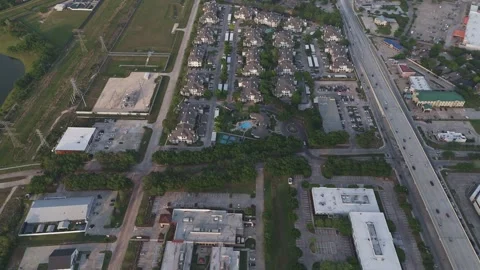 An aerial drone shot looking down at a suburban area featuring a dense apartment Video stock 337825422