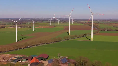 An aerial drone shot looking over a farmstead with solar roof panels and large Stock Footage 336460185