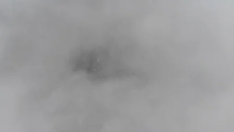 Aerial drone shot lowering down through clouds above cars Video stock 91120086