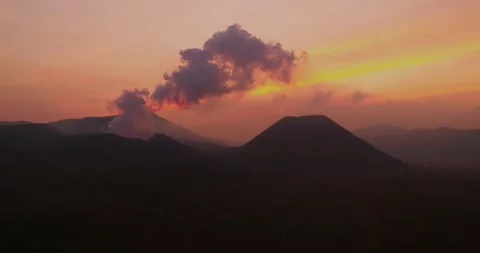 Aerial drone shot of mountain layers with sunset glow and fog Stock Footage 332035657