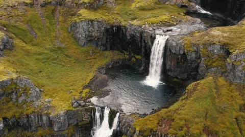 Aerial drone shot of multiple tiers of water of Klifbrekkufossar waterfall Stock Footage 116159547