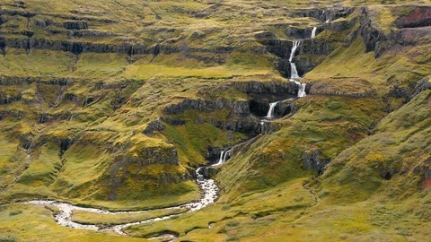 Aerial drone shot of multiple tiers of water of Klifbrekkufossar waterfall Stock Footage 116160781